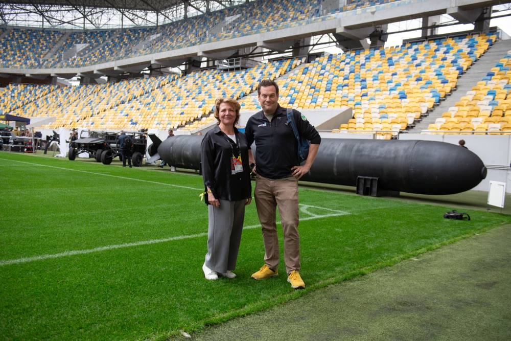Two visitors on the field of a football stadium